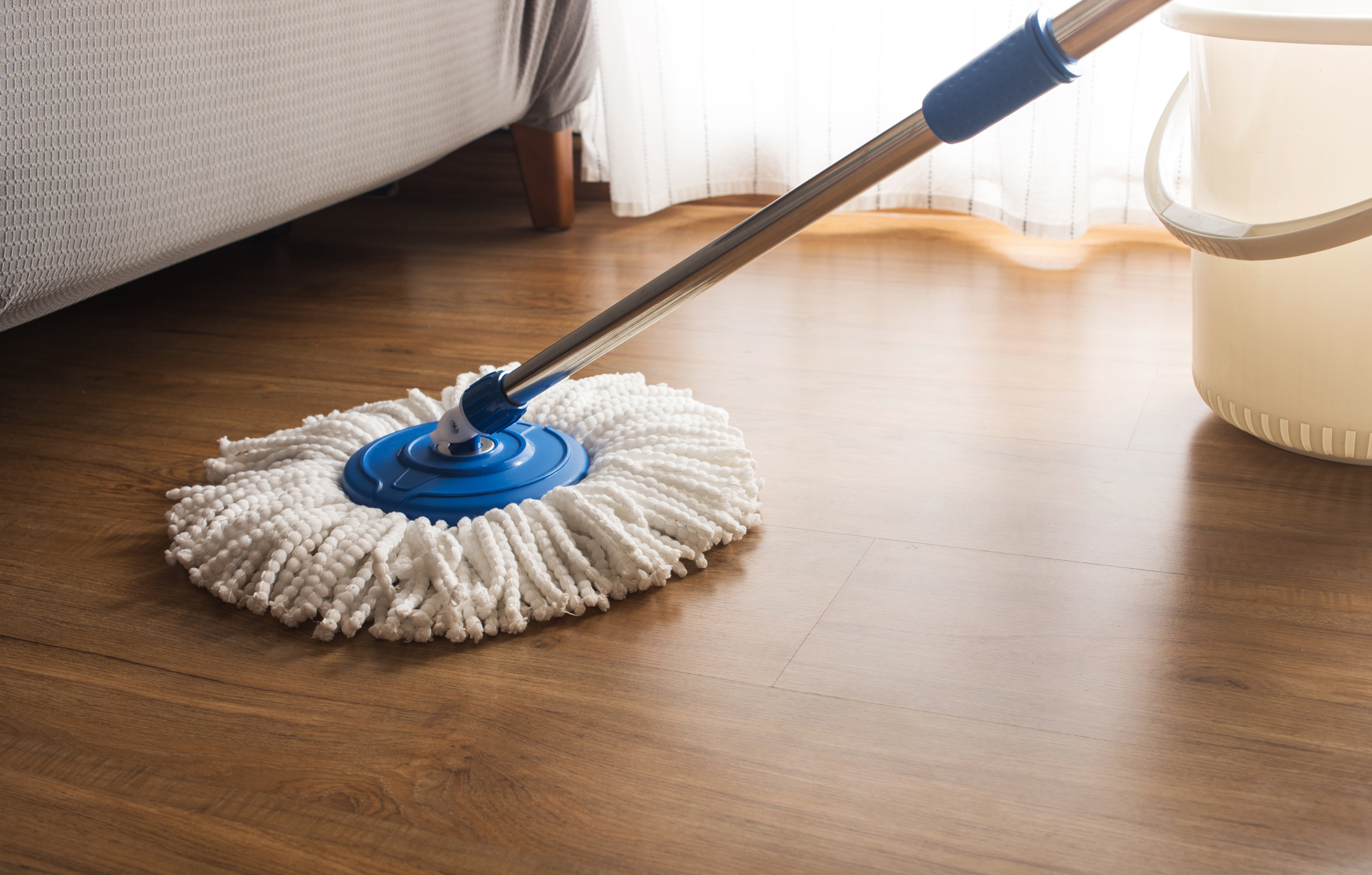 An image of someone mopping their floors - learn how to properly care for your flooring and keep it looking its best with these blogs from Footprints Floors.