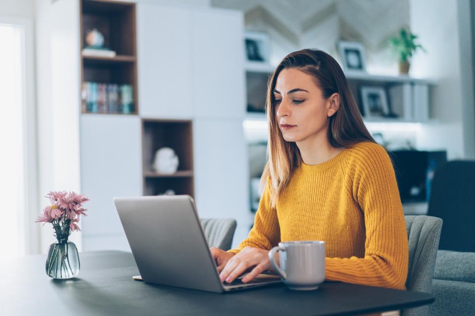 An image of a woman working from home on a computer - read about industry news regarding work-from-home franchises and how Footprints Floors supports our owners.