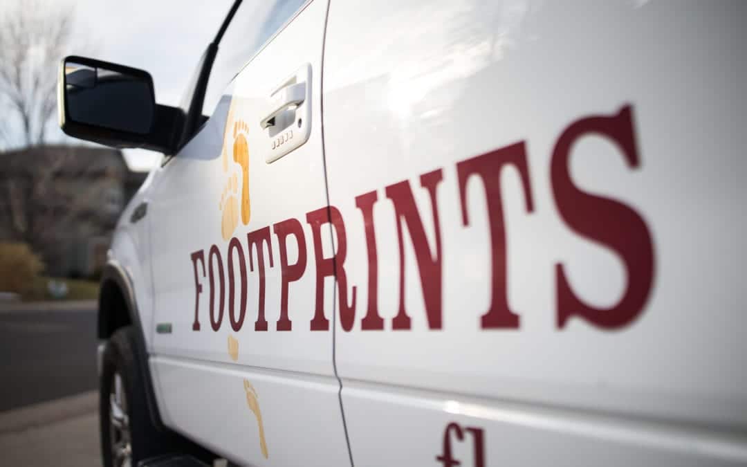 An image of the side of a Footprints Floors truck.