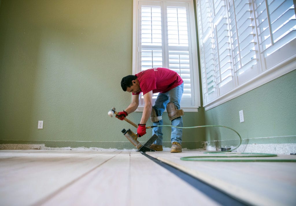 A Footprints Floors team member installing new flooring.