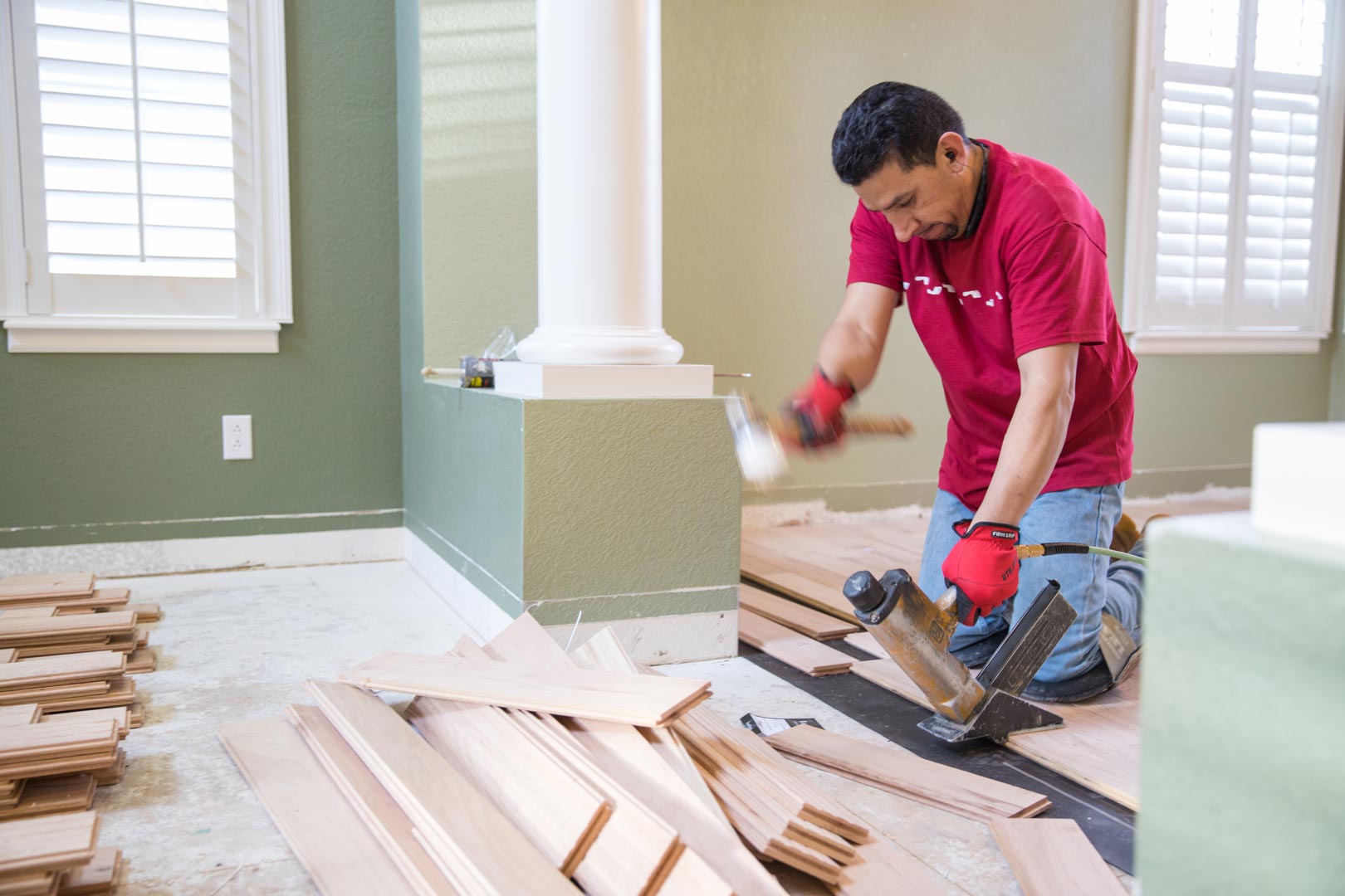 A Footprints Floors team member installing new hardwood floors.