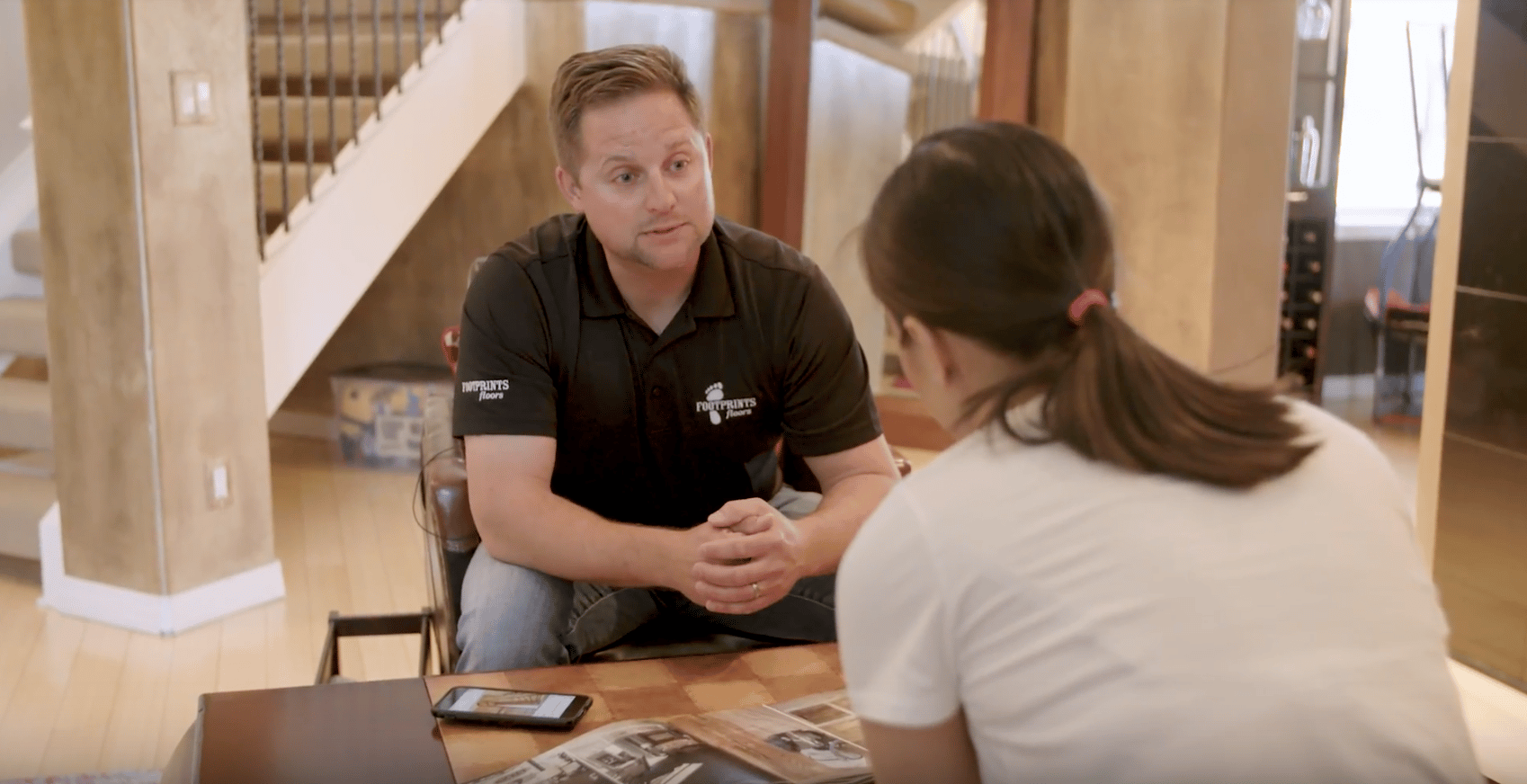 A Footprints Floors employee talking with another person - you don't needs years of experience when starting a flooring business with Footprints Floors.