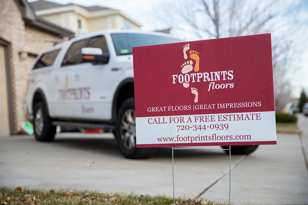 An image of a Footprints Floors service vehicle and sign - join our home improvement franchise and take advantage of an industry that remains stable through economic changes.