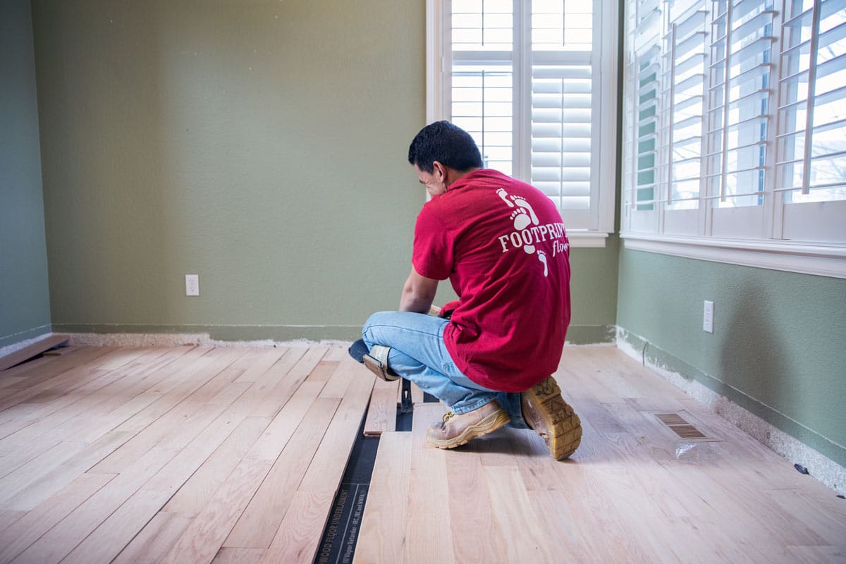 A Footprints Floors contractor working on a residential flooring project.