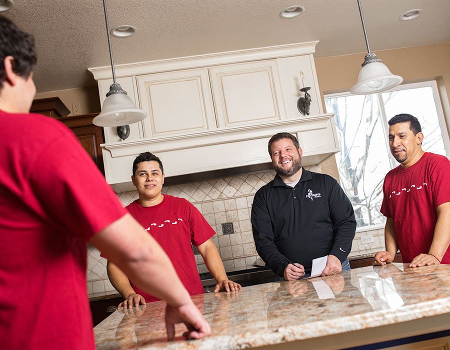 A couple of Footprints Floors team members standing in a renovated kitchen.
