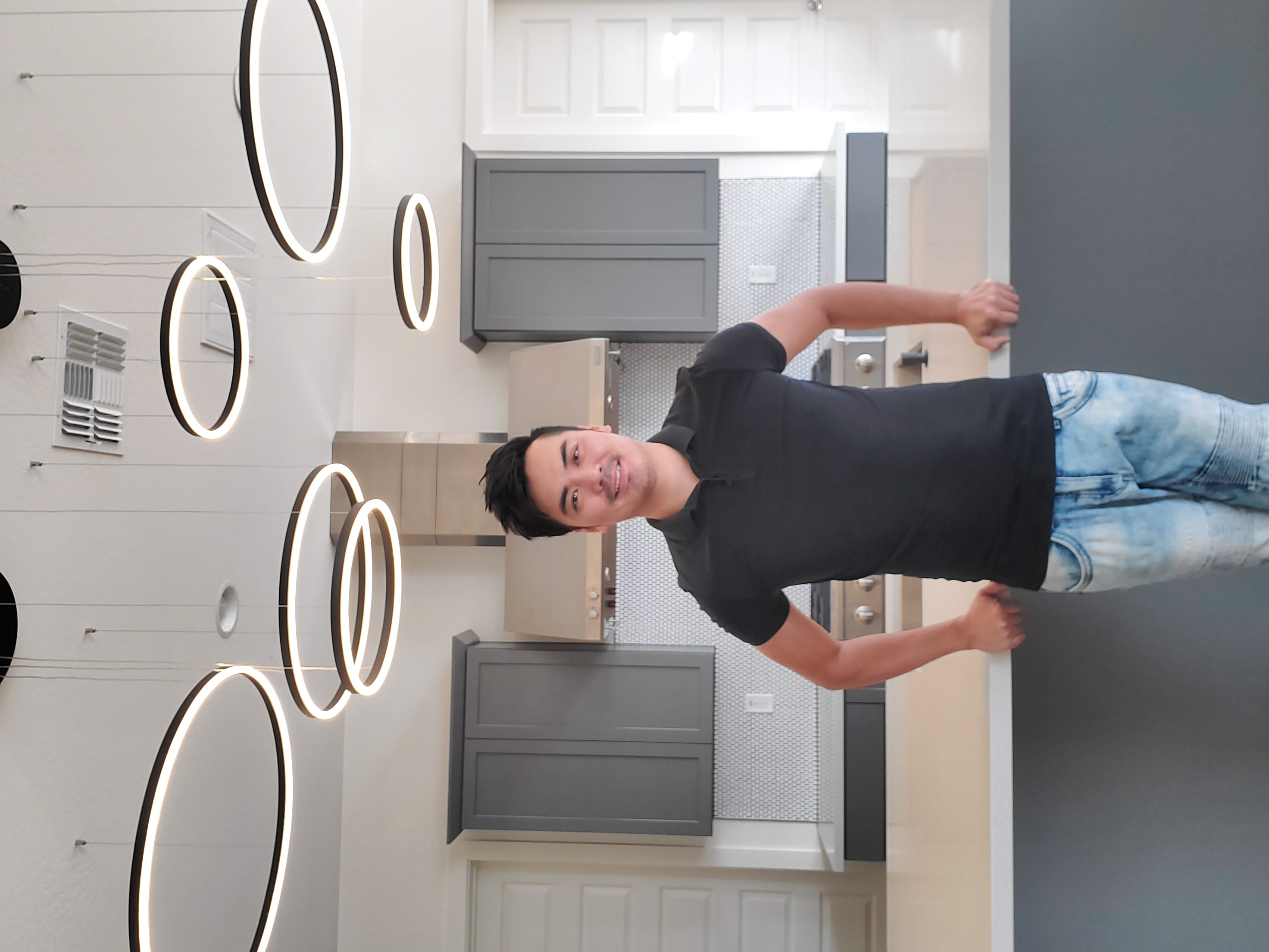 Tony Yang standing in a newly renovated kitchen.