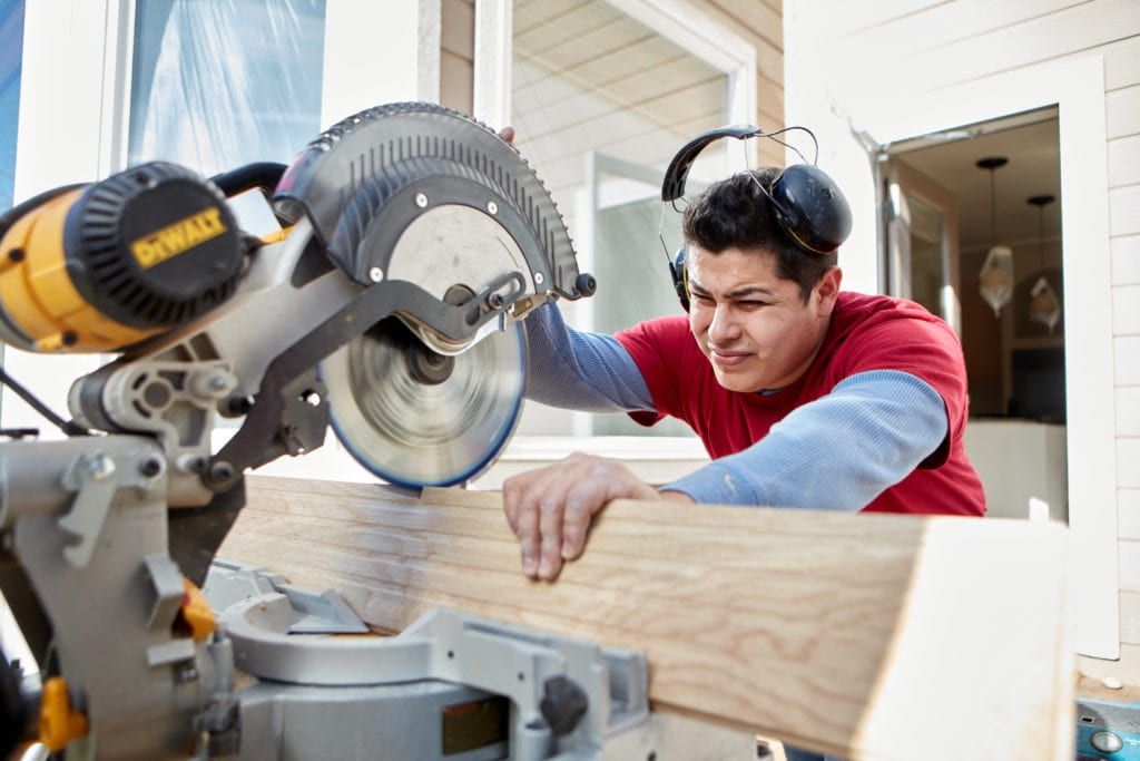 An image of a Footprints Floors contractor cutting flooring.