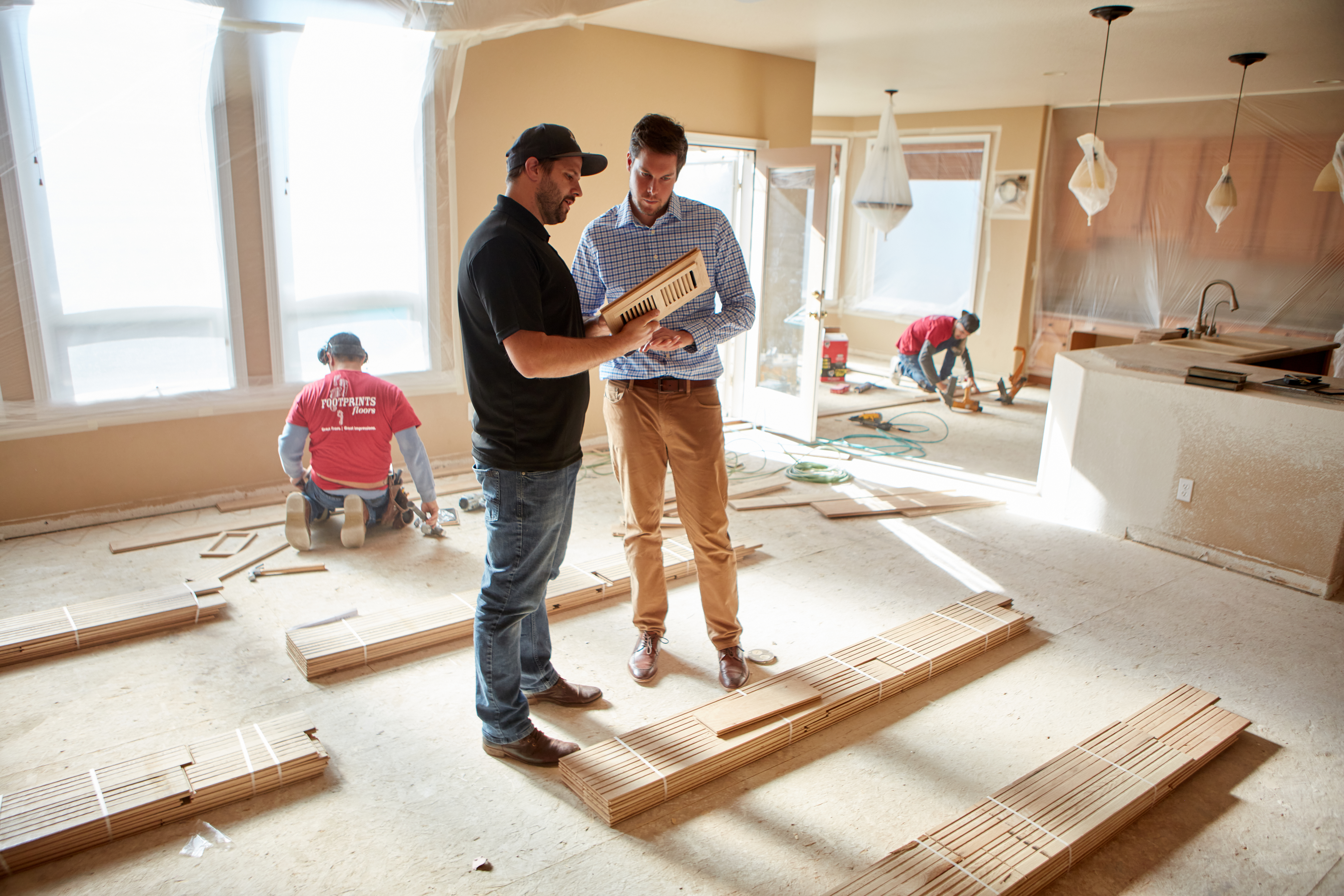 A Footprints Floors owner talking to a client about flooring options