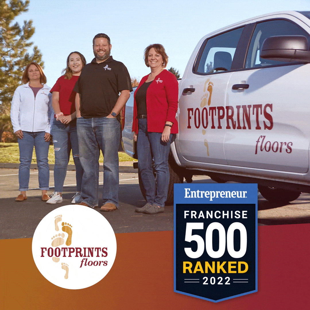 Three Footprints Floors owners standing in front of a branded truck