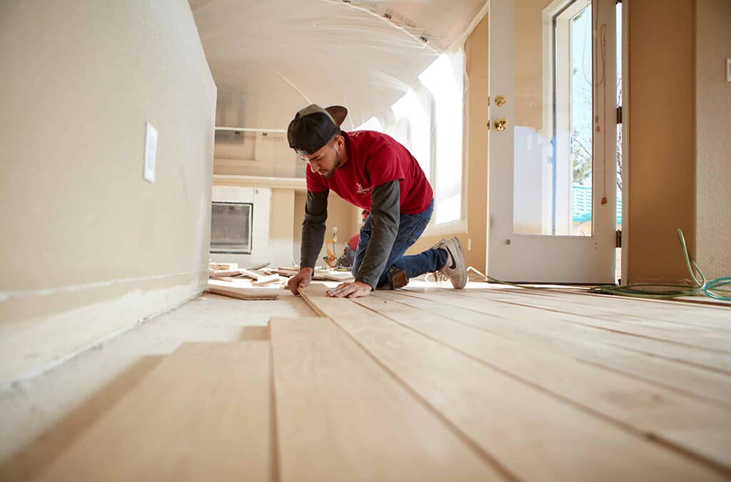 A Footprints Floors subcontractor working on installing new floors in a newly renovated home - read on to learn about the benefits of self-employment.