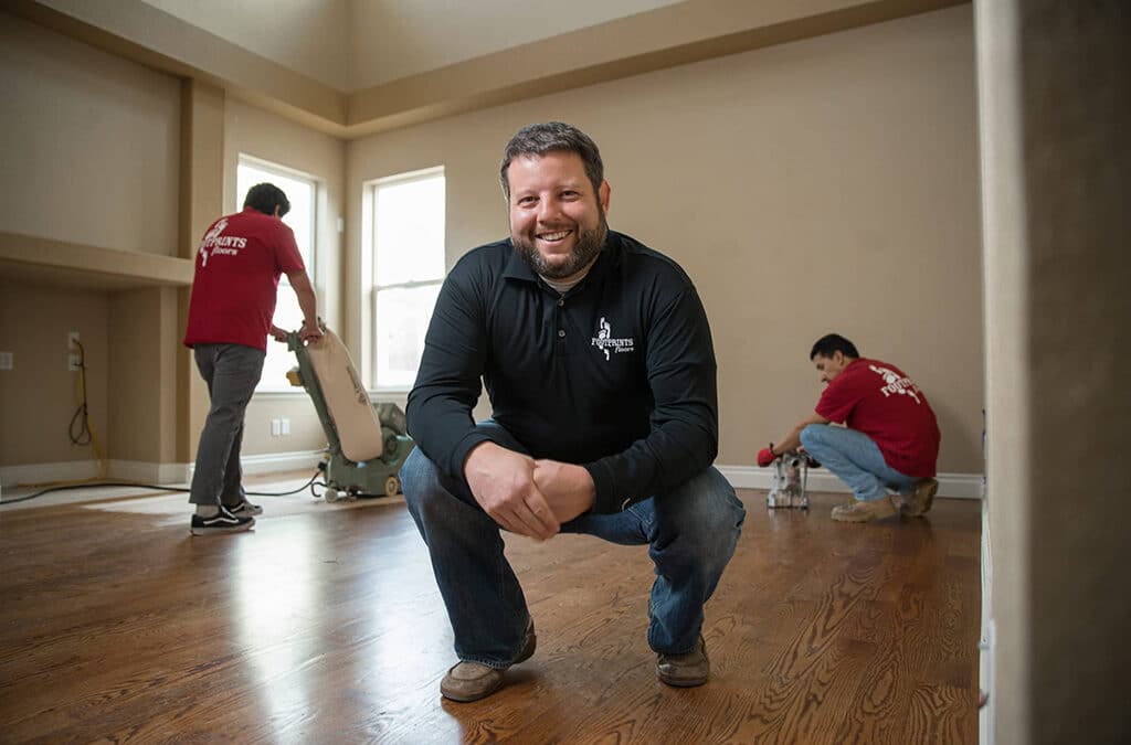 Bryan Park, CEO, sitting in a room that is haveing new floors installed.