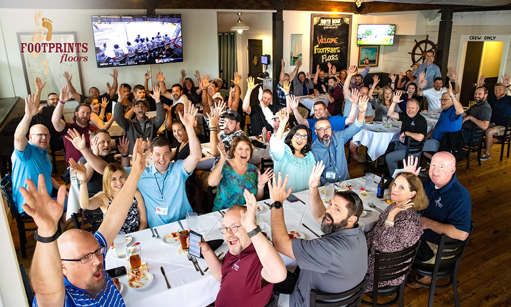 An image of Footprints Floors franchise owners and team members together.