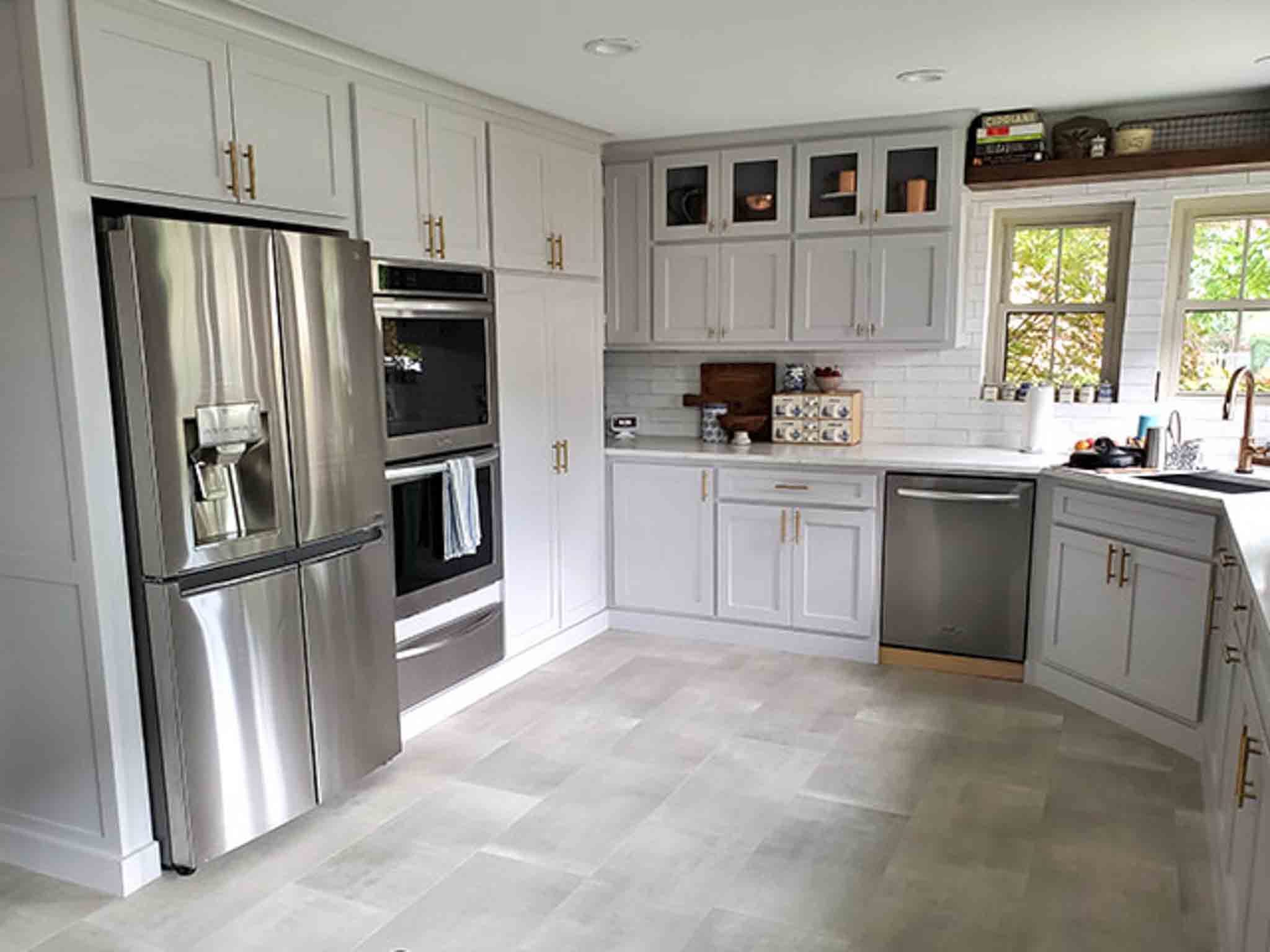 Grey tile flooring and glass backsplash installed by Footprints Floors of the MidSouth.