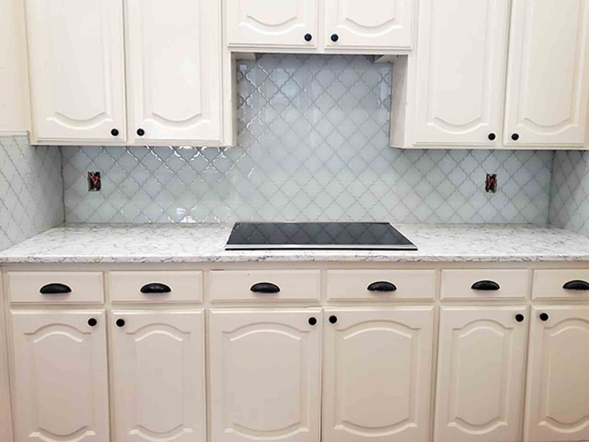 Grey tile flooring and glass backsplash installed by Footprints Floors of the MidSouth.