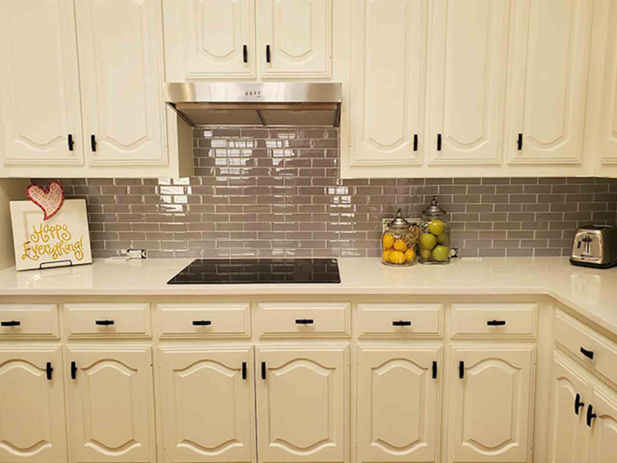 Grey tile flooring and glass backsplash installed by Footprints Floors of the MidSouth.