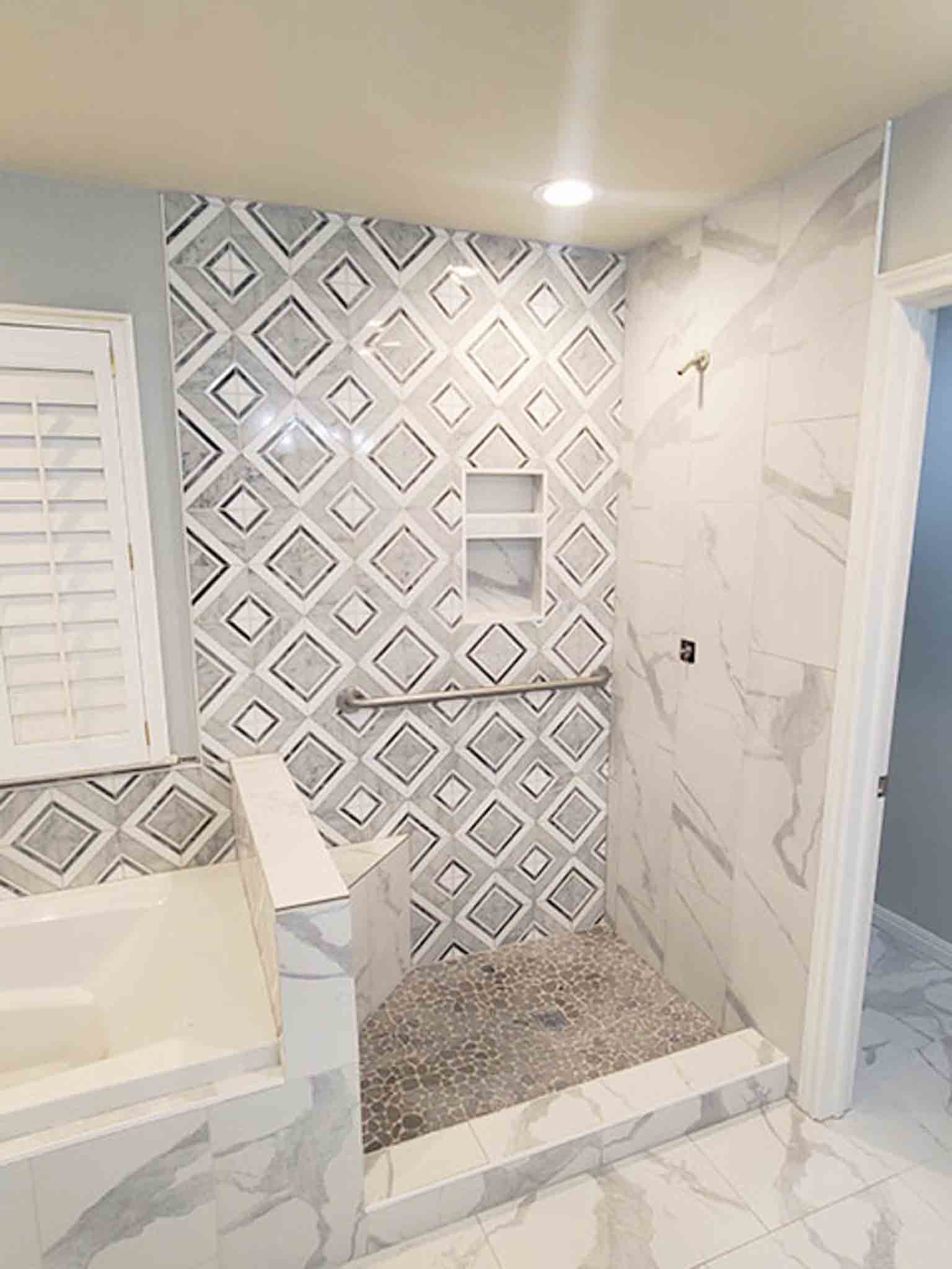 A white tile bathroom with a stand up shower, done by Footprints Floors of the MidSouth.