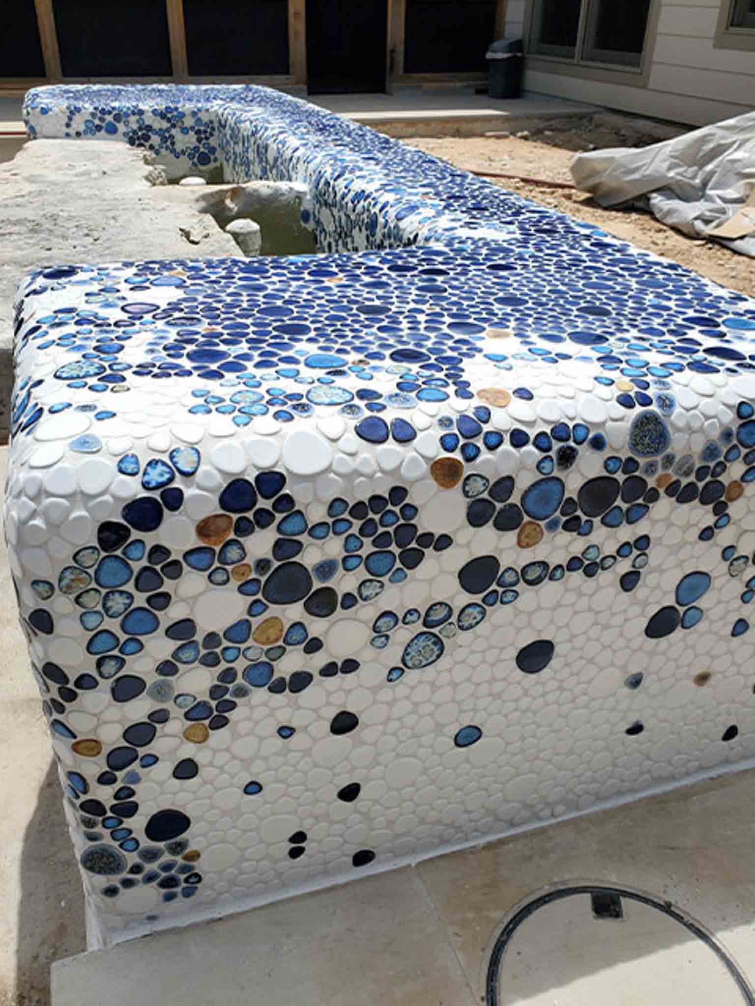 An outdoor fountain with blue tile, done by Footprints Floors of the MidSouth.