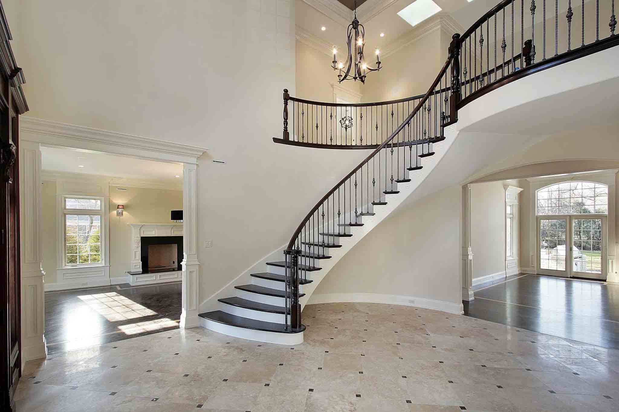 A large grand staircase with wood flooring.