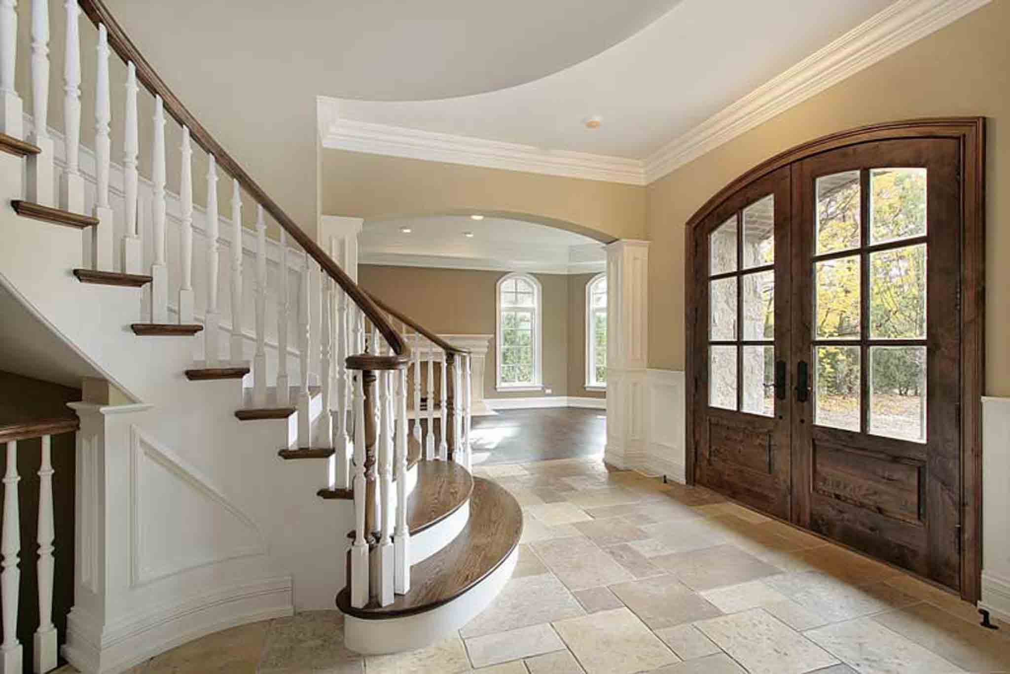 An entryway staircase with wood flooring and tile. 