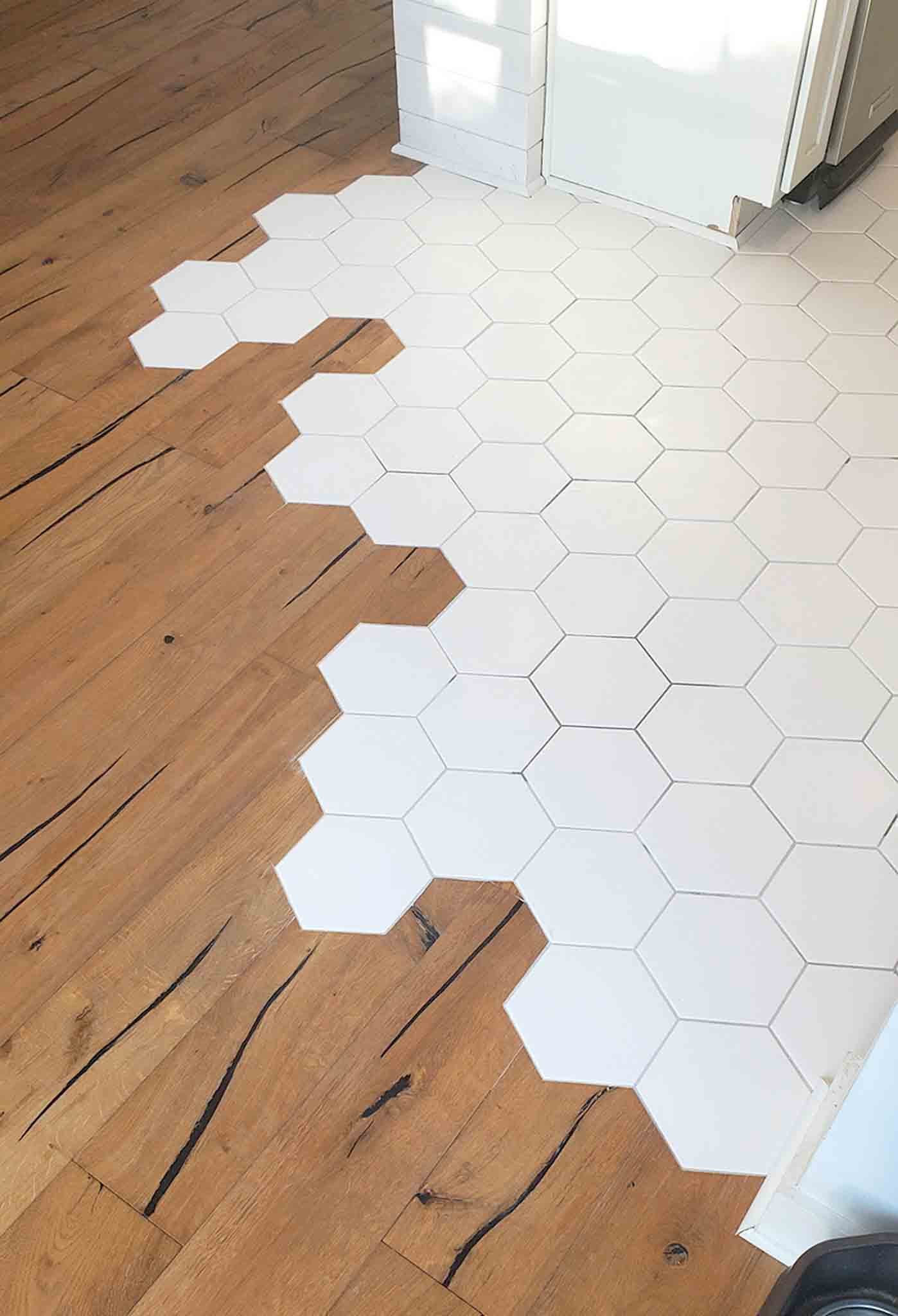 White hexagon tiles and wood flooring, installed by Footprints Floors of the MidSouth.