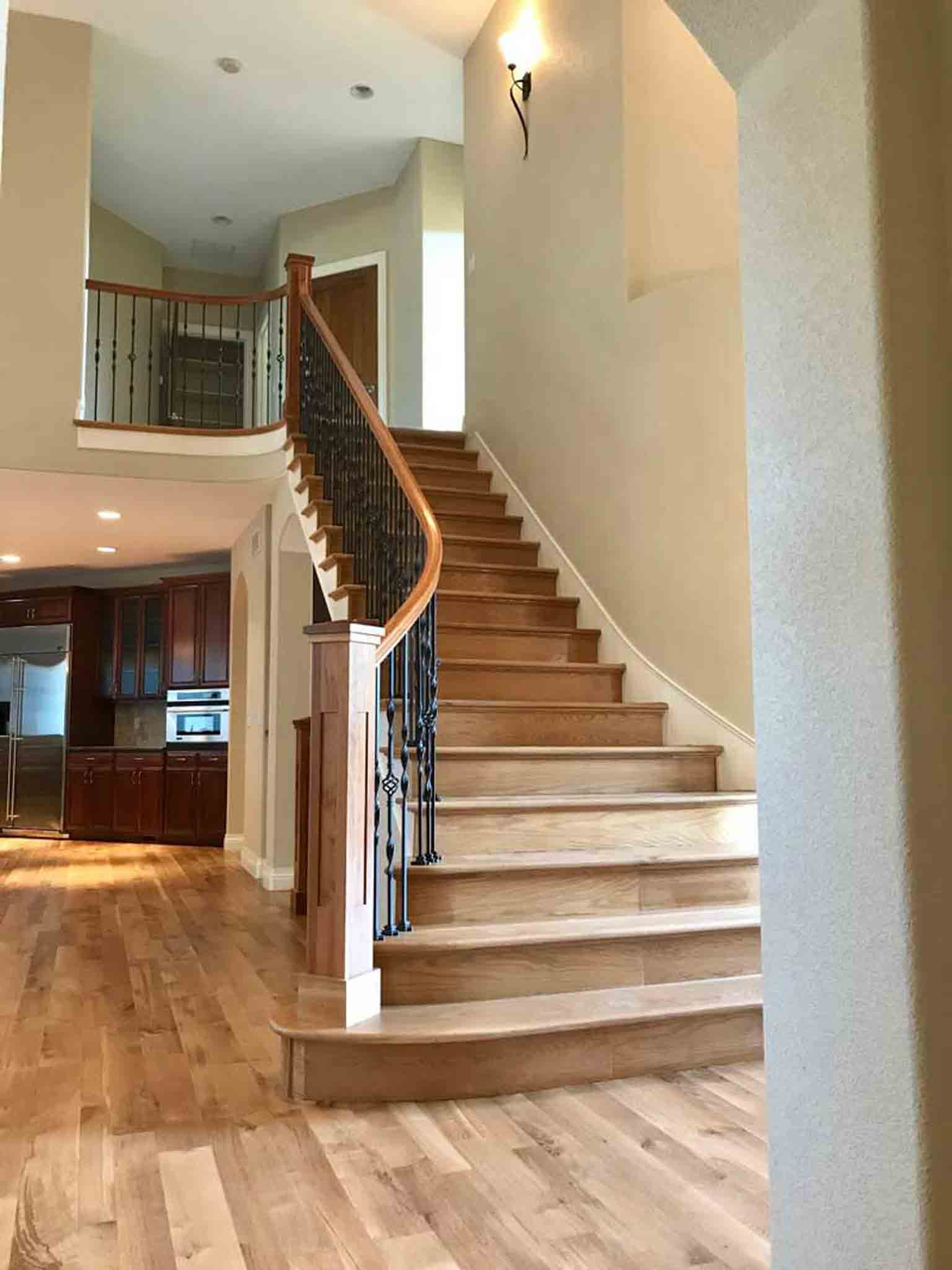 A staircase with light brown wood, installed by Footprints Floors of the MidSouth.