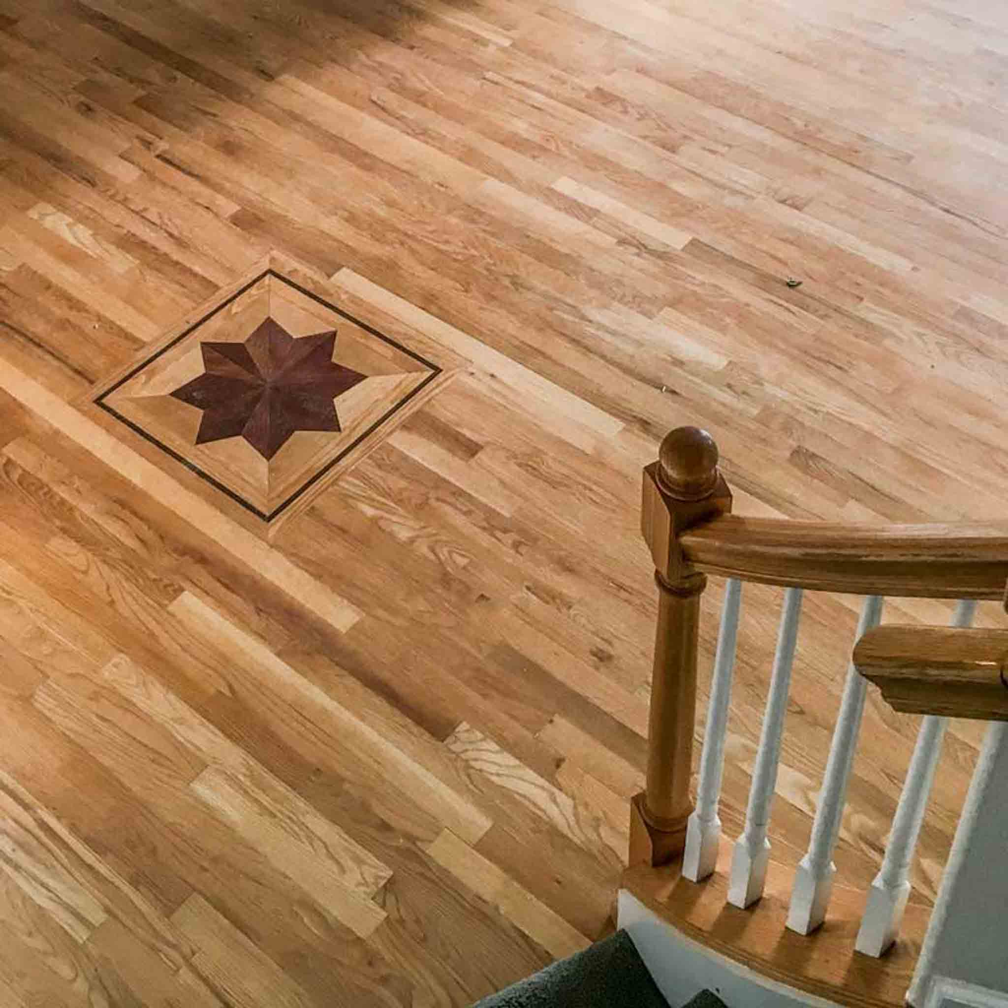 A wood floor with a star design, done by Footprints Floors of the MidSouth.