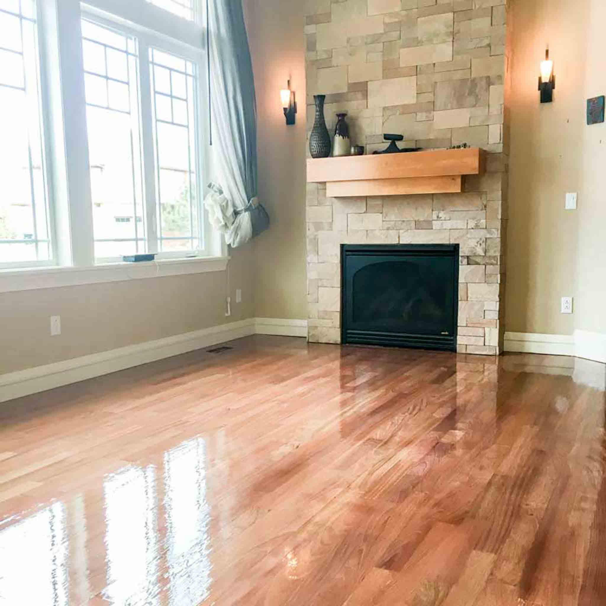 Dark wood floor installed by a fire place.