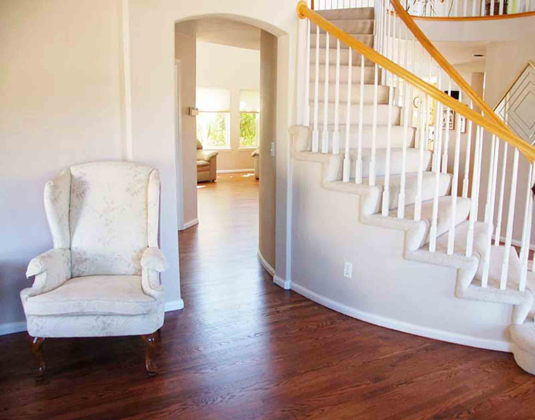 Dark brown wood flooring surrounding a staircase with carpet, installed by Footprints Floors of the MidSouth.