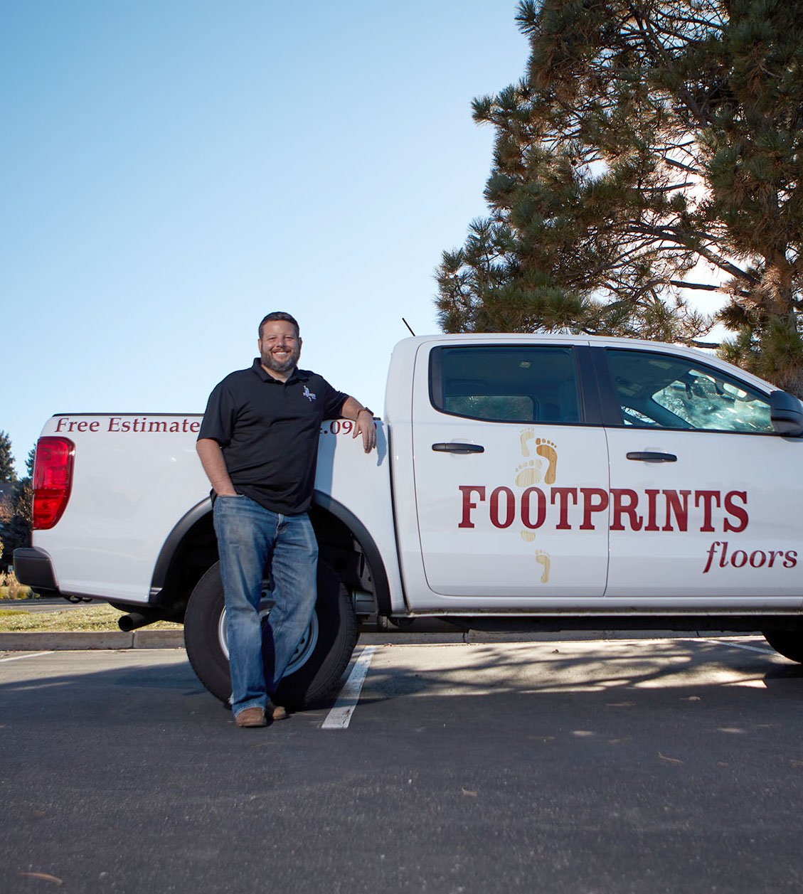 A picture of Footprints Floors founder Bryan Park in front of a company truck - contact us today to learn more about starting a flooring a installation business!