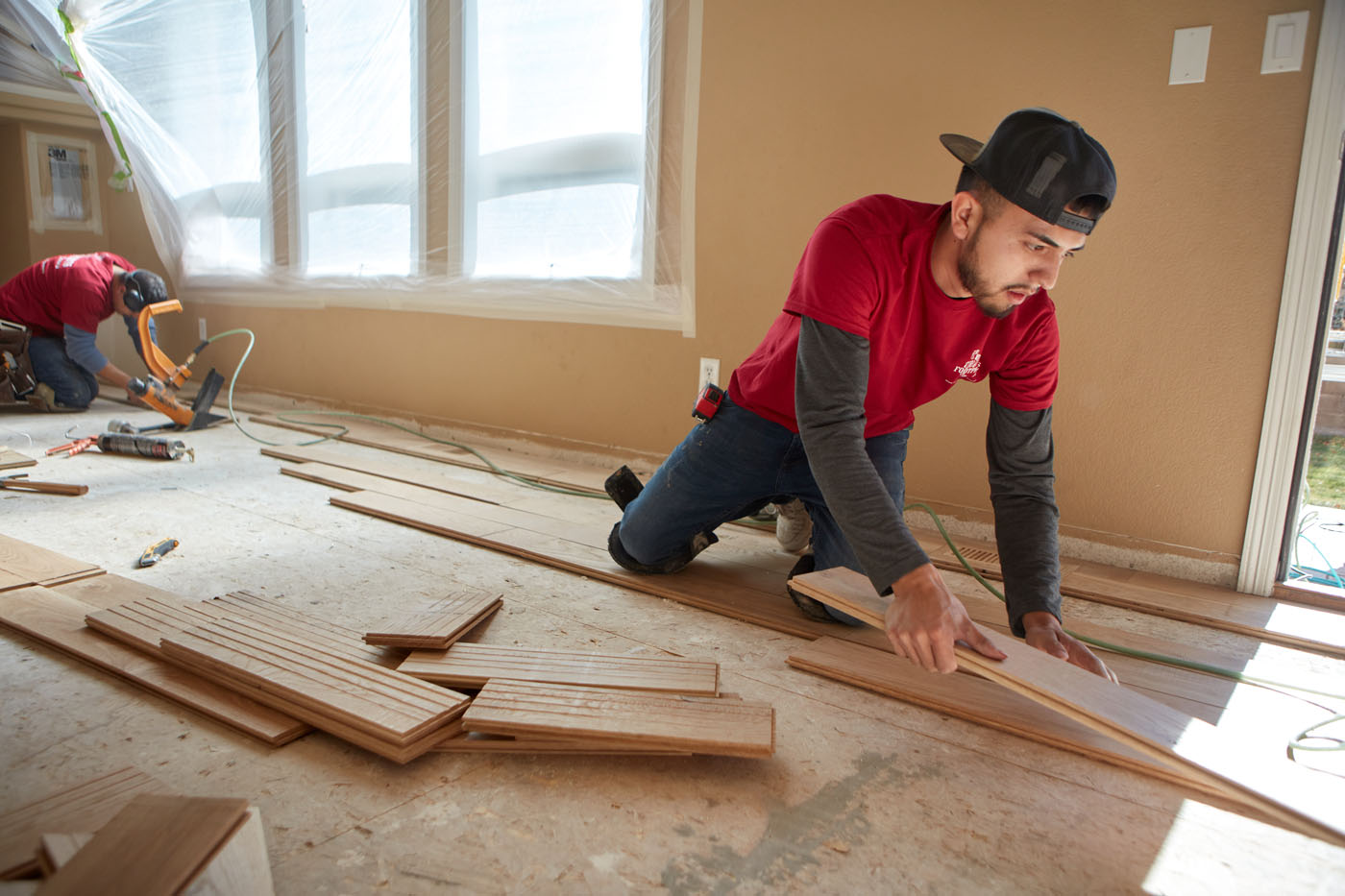 A Footprints Floors expert installing new floors - learn the difference between franchises and why service is one of the best industries to enter.