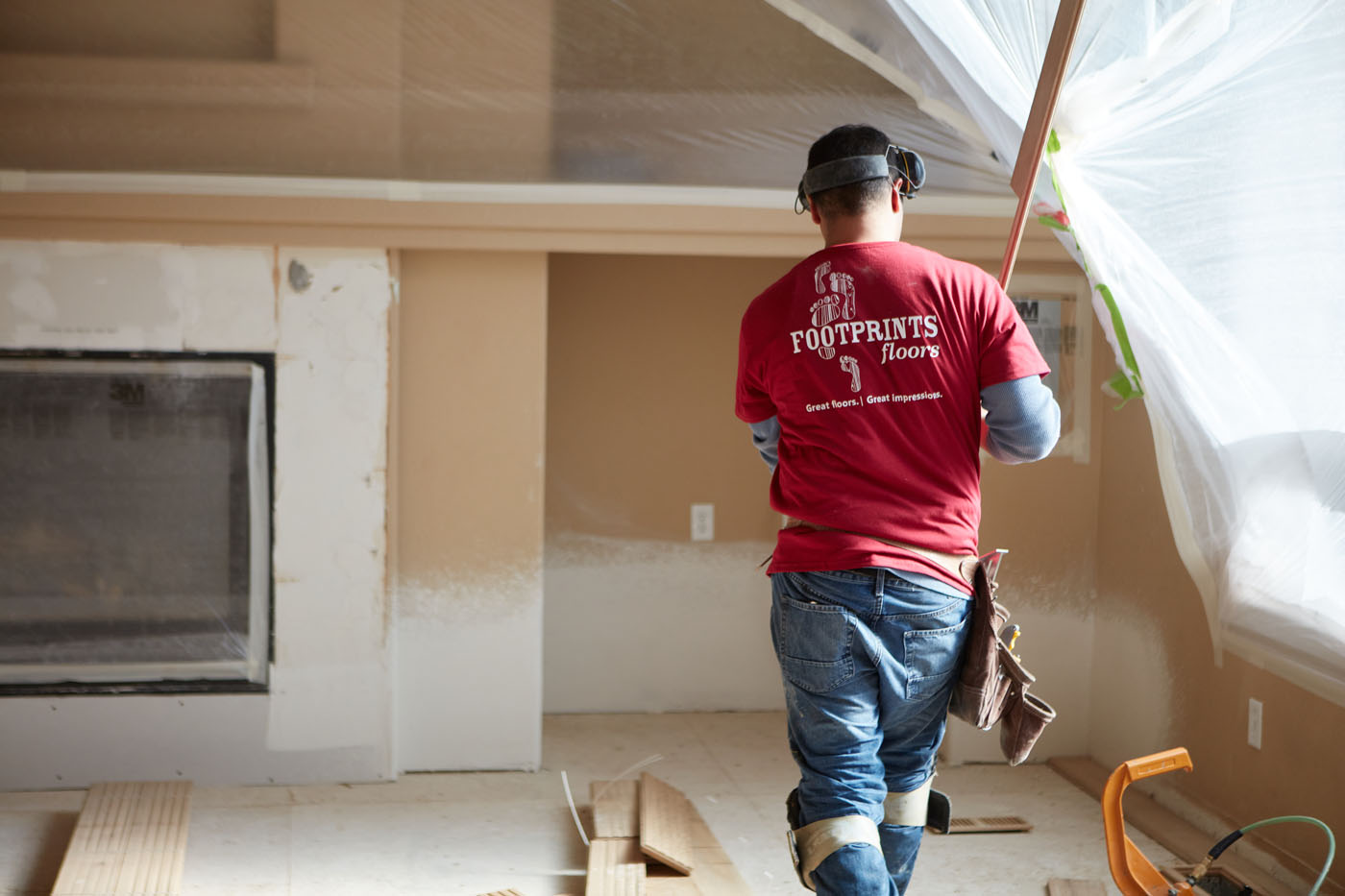A Footprints Floors flooring professional providing installation services for a residential home - learn more about our floor franchise opportunities today.