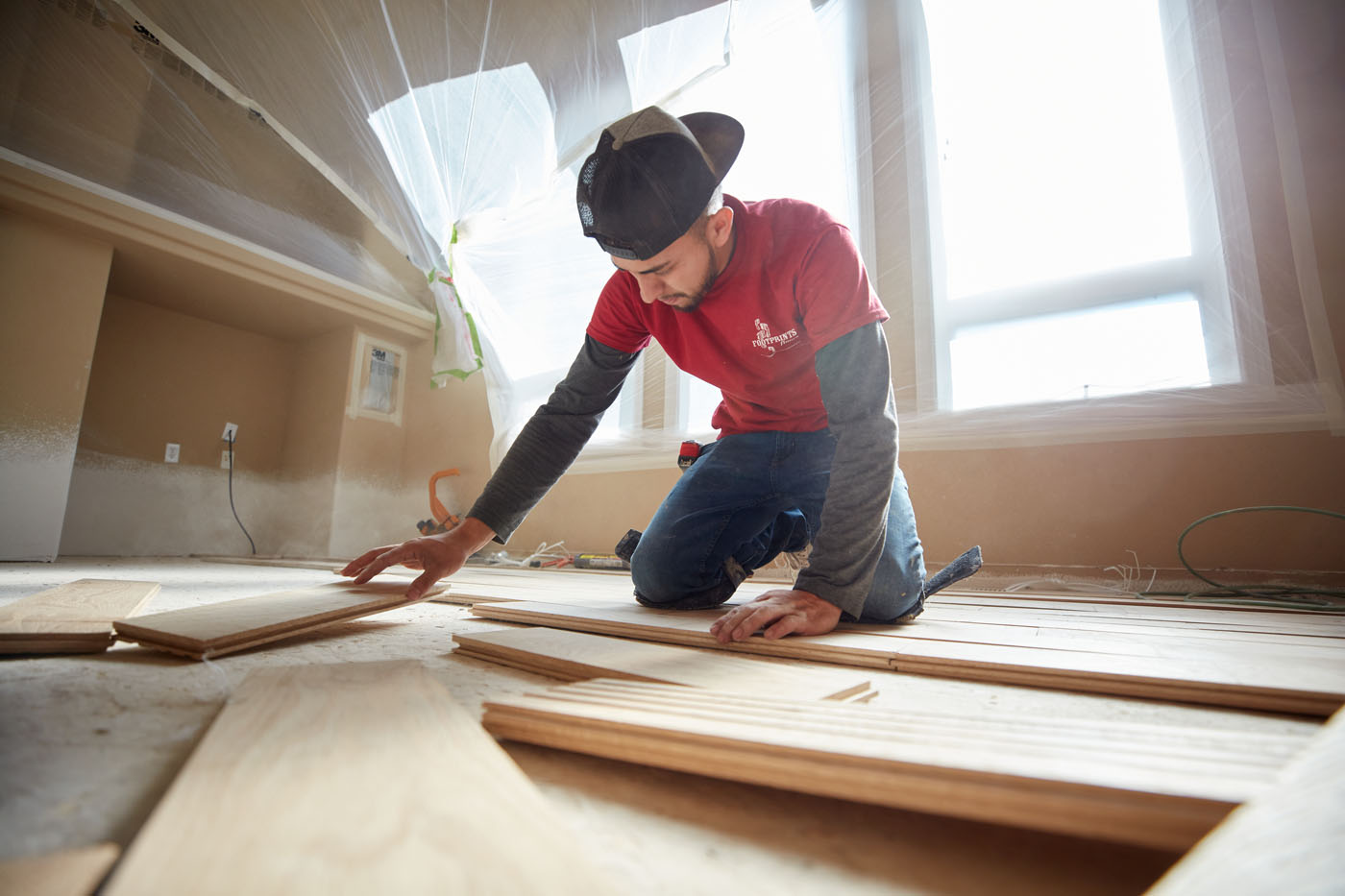 A Footprints Floors expert installing flooring - learn more about tile and hardwood floor installation from Footprints Floors in Reno-Sparks Metro, NV