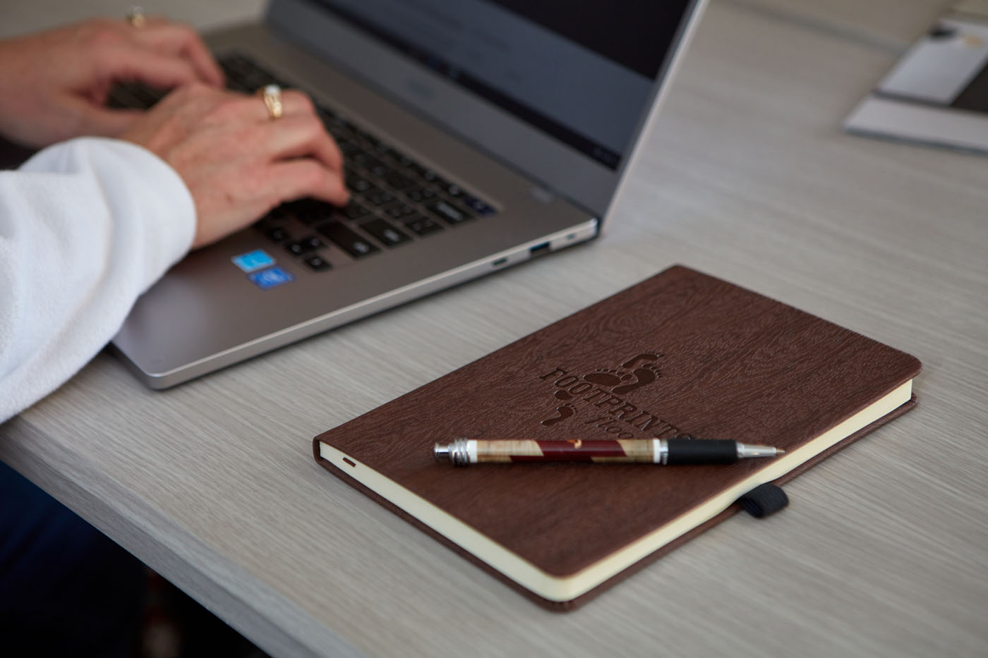 A Footprints Floors team member working on a computer - find success and personal growth with our semi-absentee franchise business model.