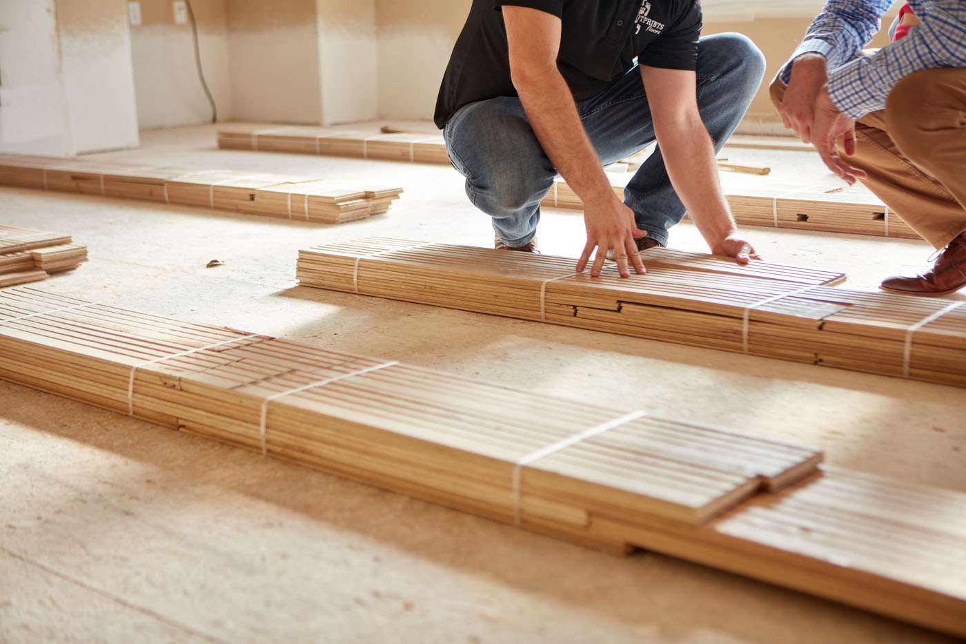 An image of Footprints Floors employee working with a client on their project - get started on yoru semi-absentee franchise today.