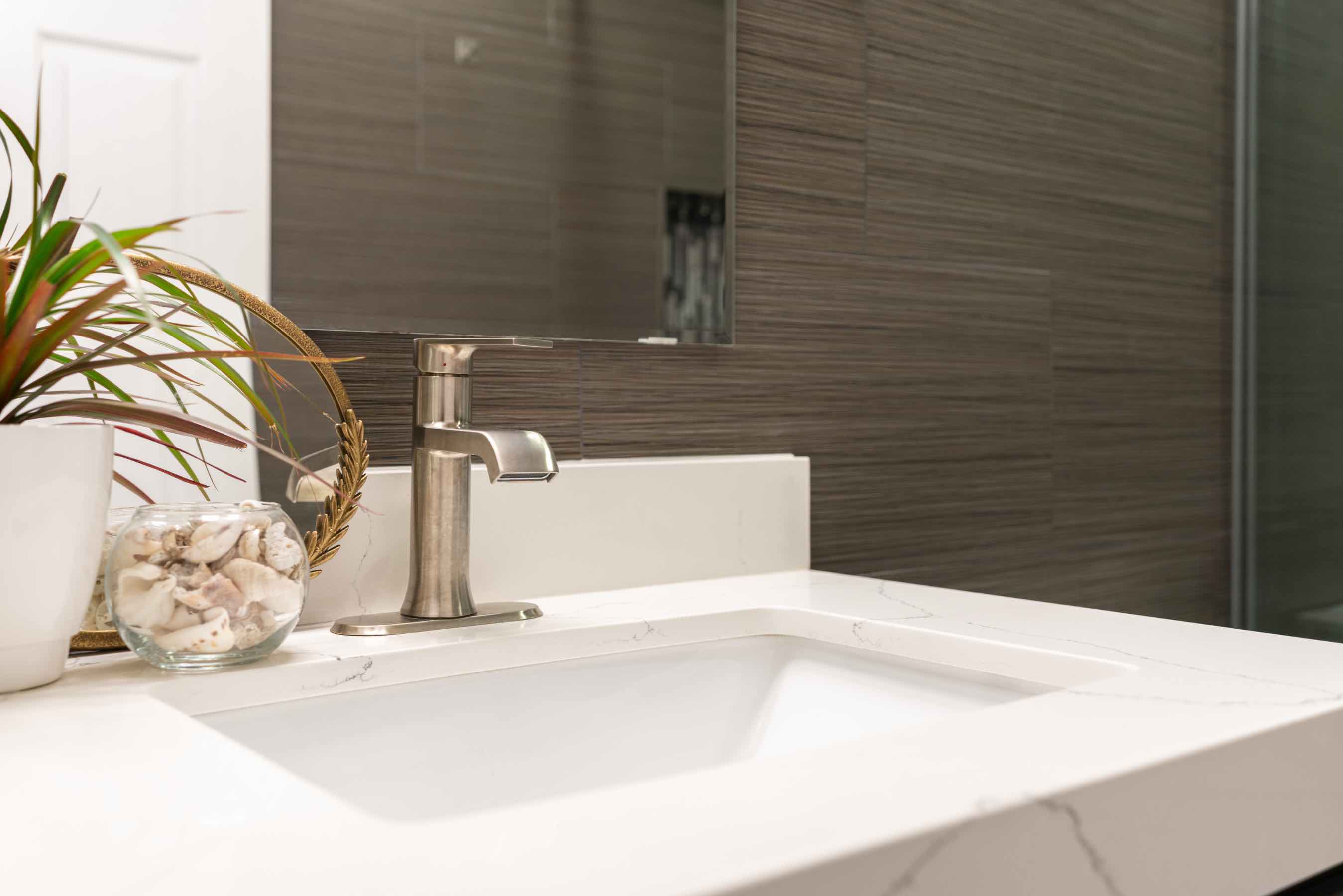 For sleek, modern bathroom backsplash installation like this in Aurora, call Footprints Floors.