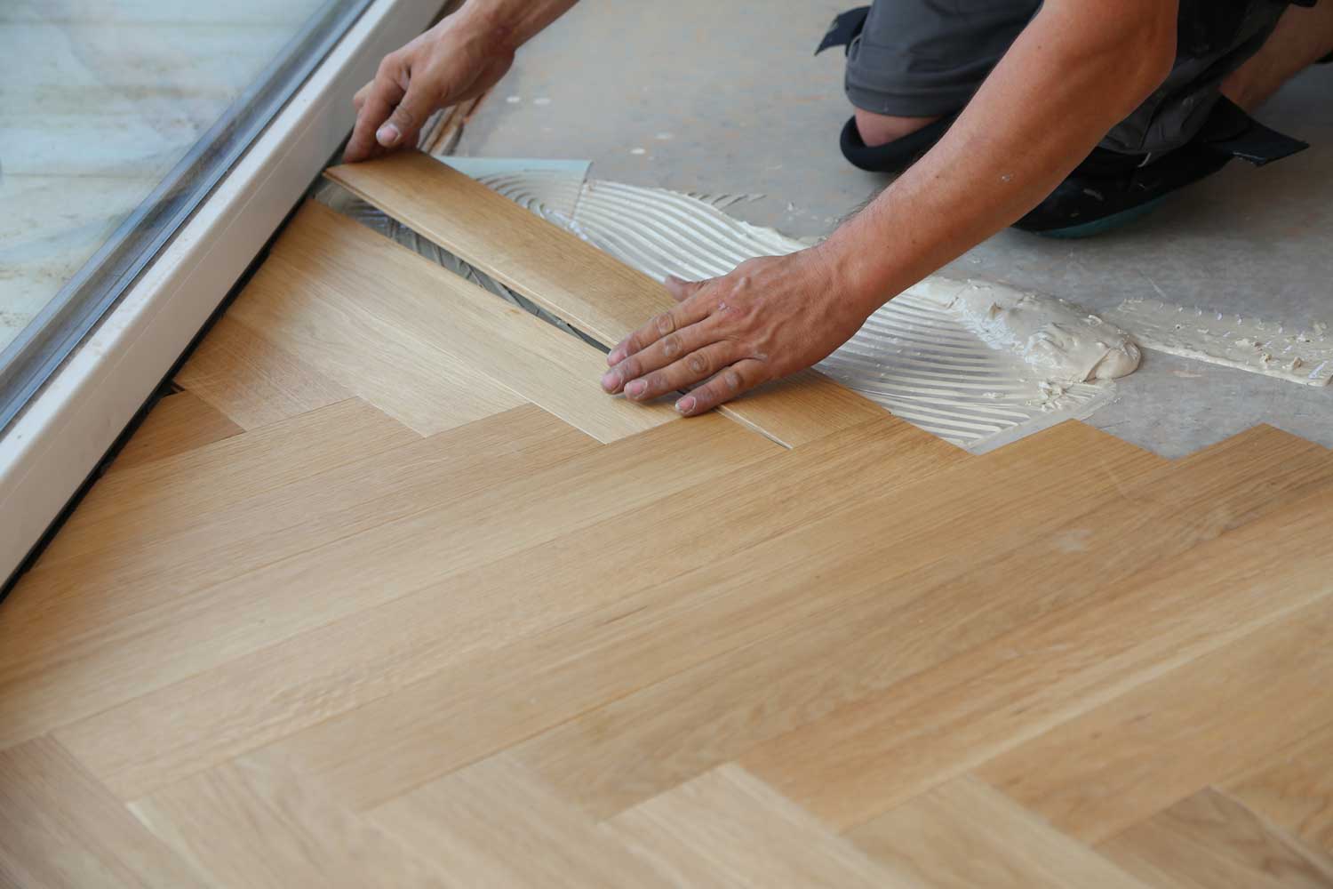 Footprints Floors in Reno-Sparks Metro, NV employee installing hardwood flooring. 