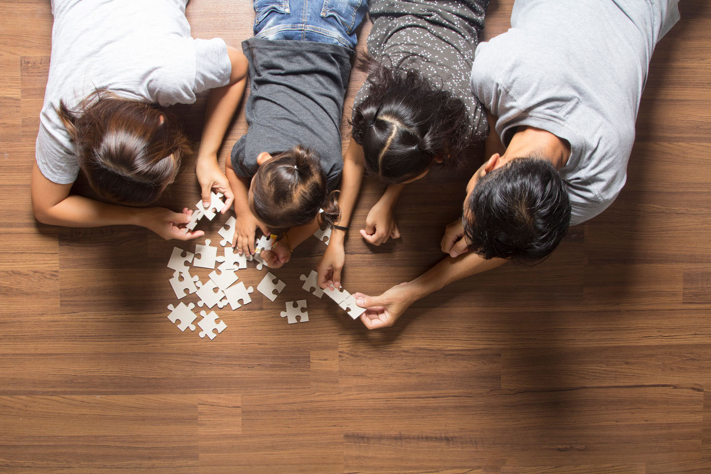 A family playing on clean vinyl flooring installed by Footprints Floors.