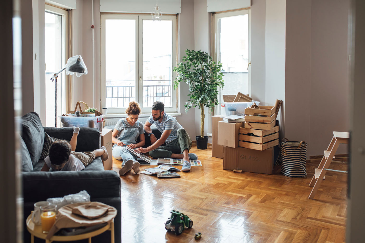 A picture of a couple looking through design catalogs on beautiful flooring - find floors that fit your lifestyle with this question guide from Footprints Floors.