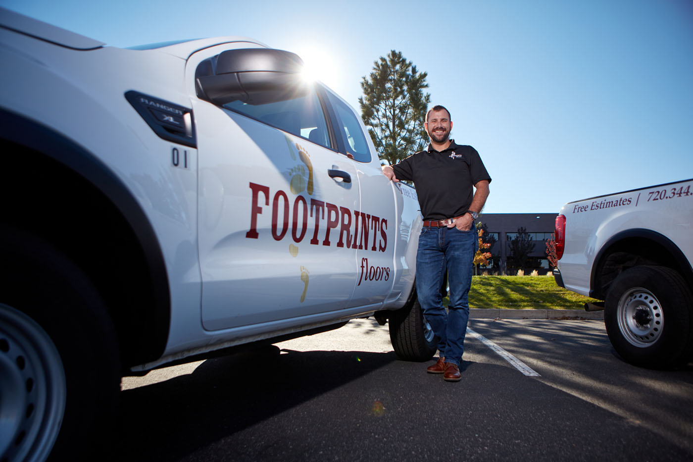 Footprints Floors owner standing by a truck, select one of our locations near you.