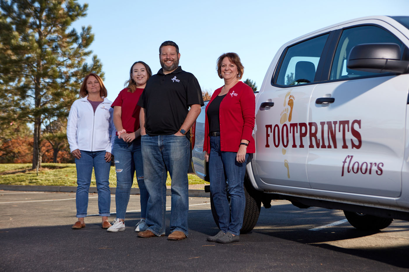Footprints Floors Founder Bryan Park with a group of franchisees in front of a company truck.