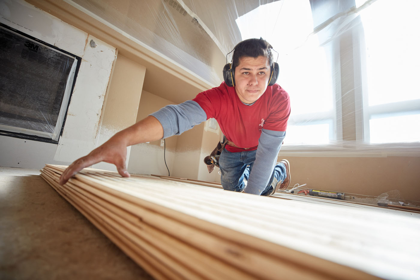 A Footprints Floors Western Nevada  team member laying down revel woods products for new flooring in Reno-Sparks Metro, NV.