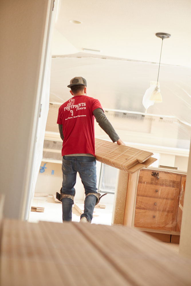 A Footprints Floors of the MidSouth worker installing flooring in Arlington / Collierville, TN.