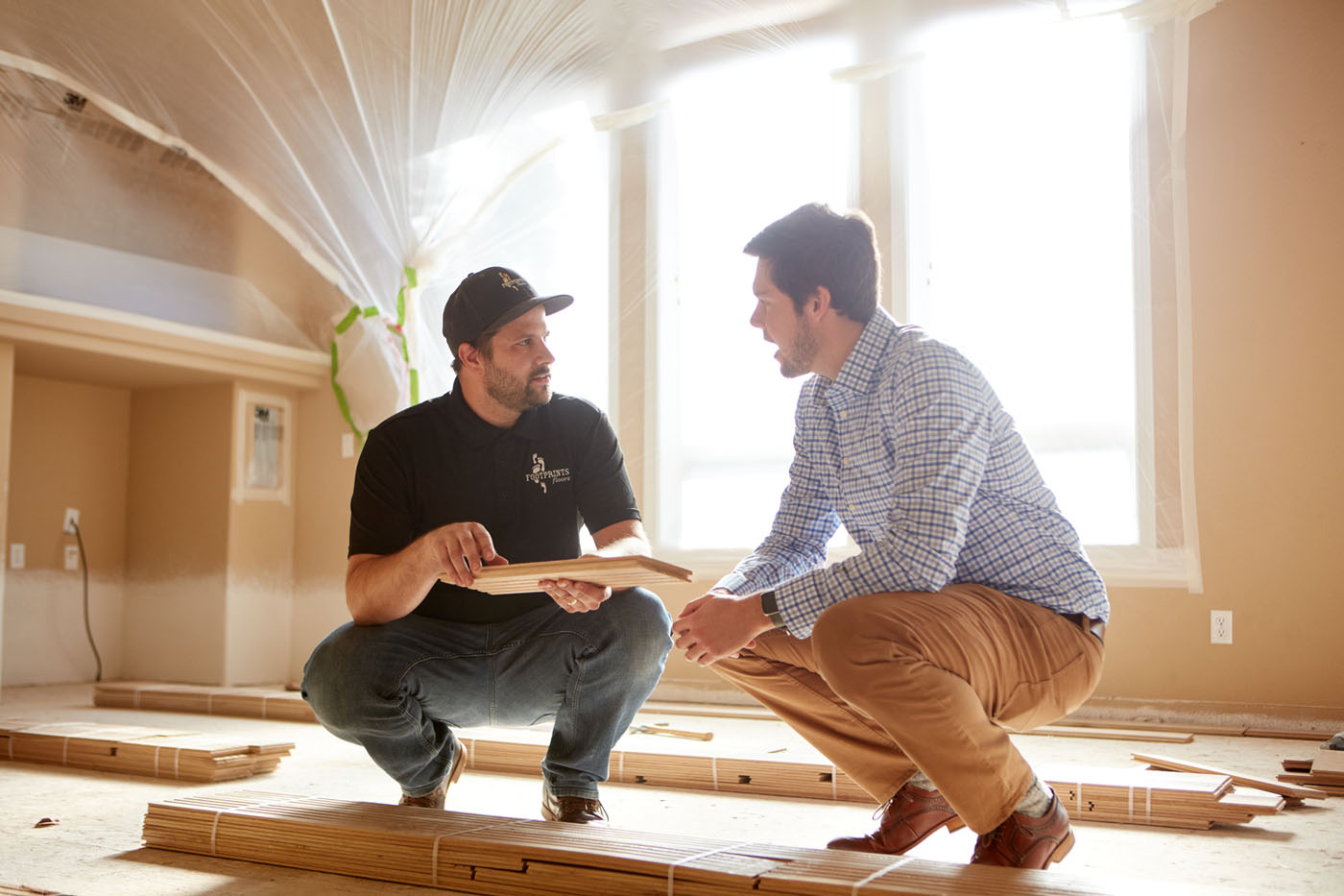 A Footprints Floors expert working with a homeowner - read our guides and questions to better understand our processes.