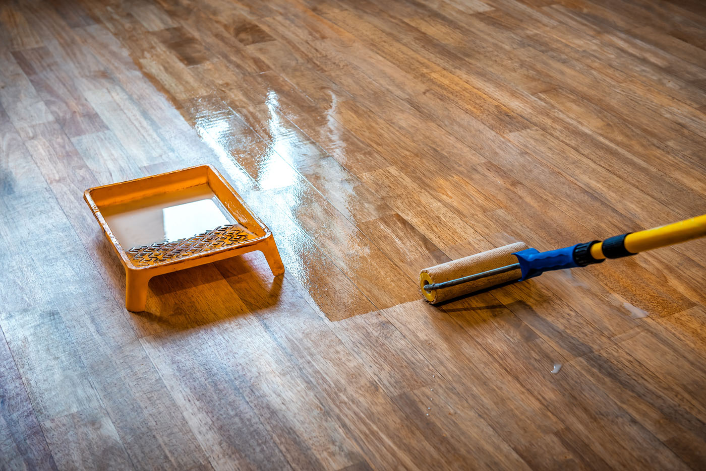 Dark hardwood floor getting a wax coat for led cure refinishing in Peachtree City, GA.